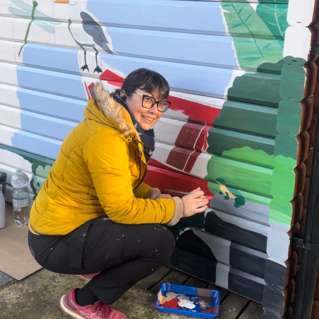 Virgine Colin designing a mural on Ray Mill Island